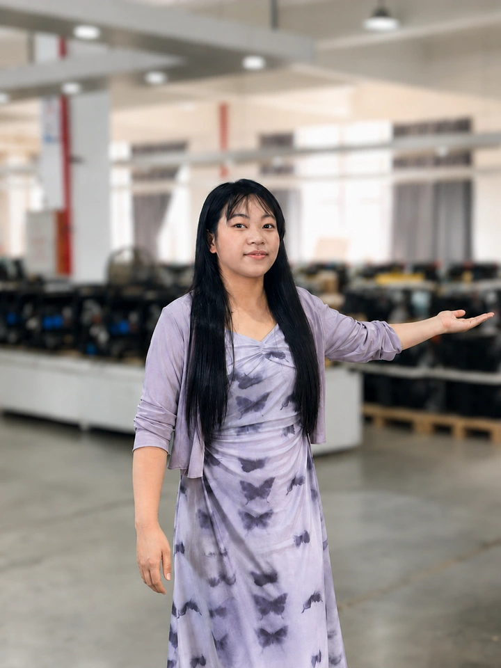 Miya in front of a softly blurred equipment display background