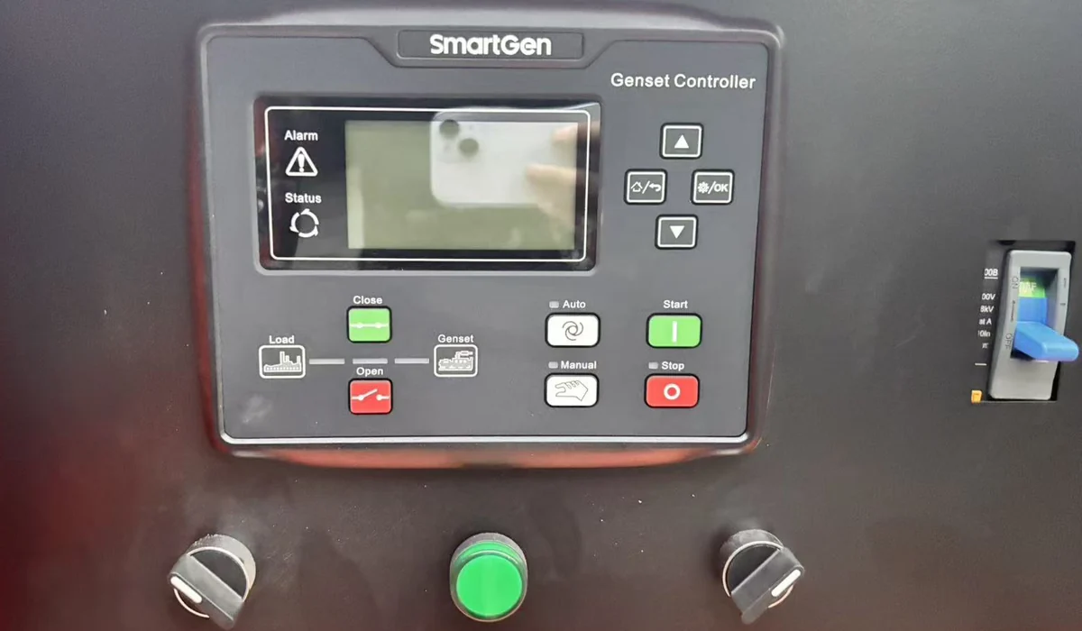 SmartGen genset controller on the SG 30 kW generator, with display, Auto, Manual, Start and Stop keys, a green push button and two key switches below